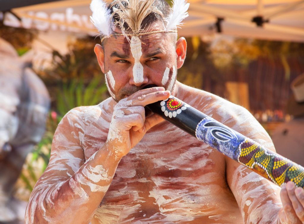 Indigenous man playing the didgeridoo at Sydney Zoo